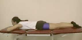 Image of patient lying flat on their tummy with the head supported on folded arms.