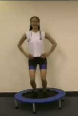 Photograph of patient on the mini trampoline, absorbing the impact on landing from a small jump.