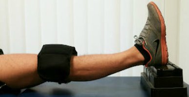 The foot is rested on something like some books, and the knee allowed to stretch. Additional weights may be helpful.