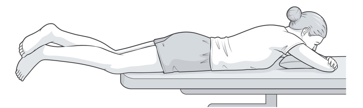Patient lying prone with legs unsupported, so that the weight of the limb aids extension.